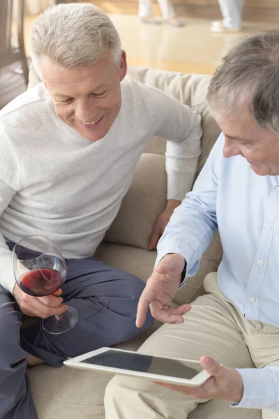 Mature Men Using Digital Tablet While Sitting Sofa Home — Stock Photo, Image