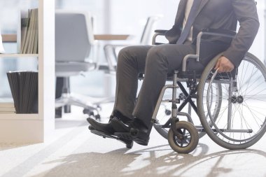 Modern ofiste tekerlekli sandalyeengelli işadamının düşük açılı görünümü