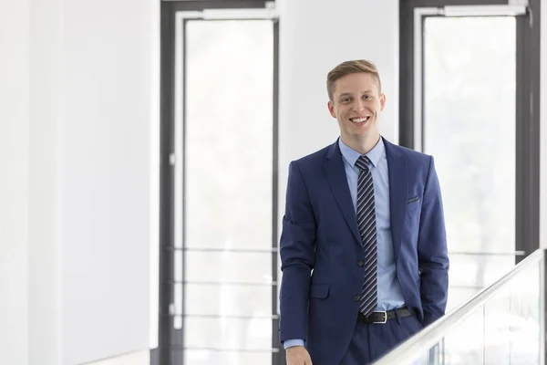 Portrait Smiling Young Businessman Standing Window Office — Stock Photo, Image