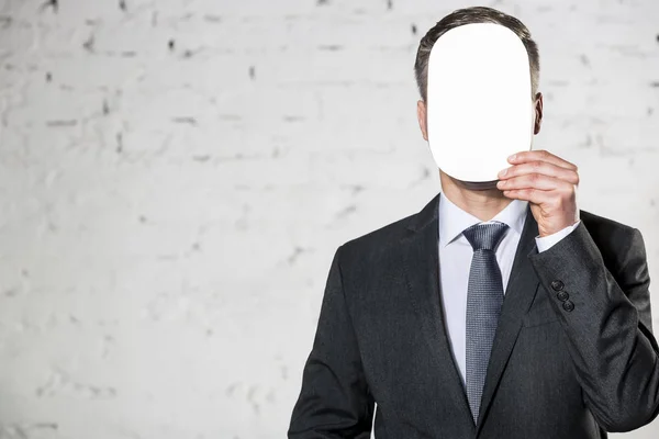 Mature Businessman Covering Face Blank Paper White Brick Wall Office — Stock Photo, Image