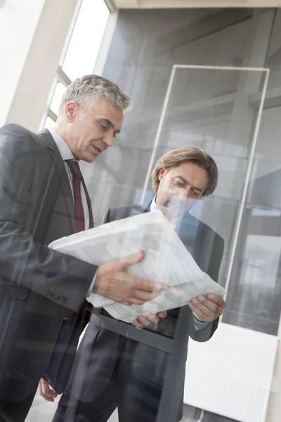 Mature Businessmen Discussing Document While Standing New Office — Stock Photo, Image