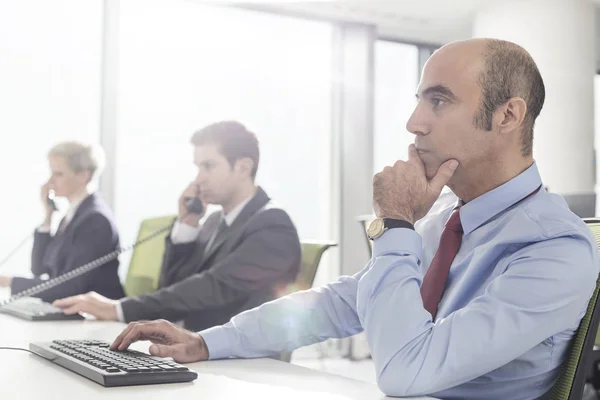 Thoughtful Mature Businessman Working While Sitting Desk Modern Office — Stock Photo, Image