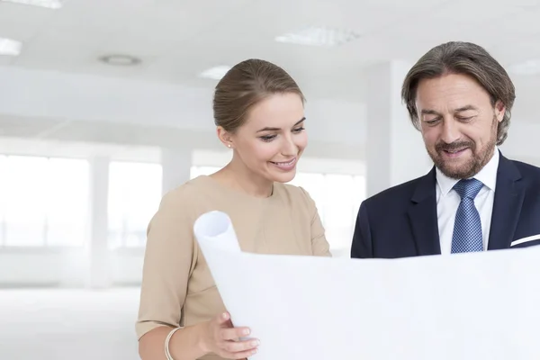 Smiling Businessman Businesswoman Looking Blueprint While Standing New Empty Office — Stock Photo, Image