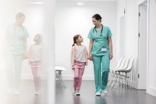 护士和女孩病人走在走廊在医院 — 图库照片