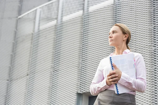 Thoughtful Businesswoman Holding Document While Looking Away Office Building — Stock Photo, Image