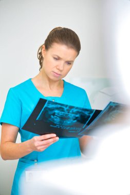 Kendine güvenen doktor diş kliniğinde tıbbi x-ray incelenmesi