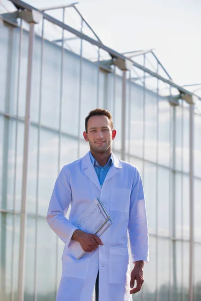 Portrait Confident Scientist Clipboard Standing Greenhouse — Stok fotoğraf