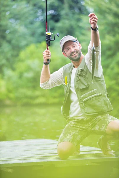 Shot Happy Man Catching Fish Lakeshore — 스톡 사진