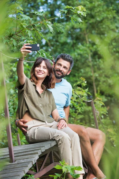 Full Length Smiling Woman Taking Selfie Man While Sitting Boardwalk — Stock Photo, Image