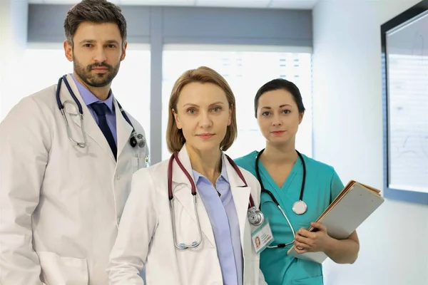 Portrait of confident medical professional team at hospital — Stock Photo, Image