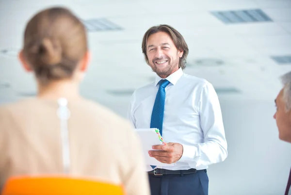 Mature businessman brainstorming colleagues at new office — Stock Photo, Image