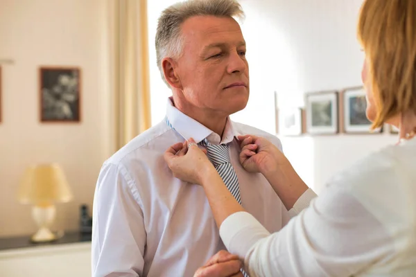 Mature Woman Adjusting Necktie Businessman Home — Stock Photo, Image