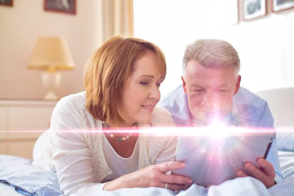 Senior Couple Watching Movie Digital Tablet While Sitting Bed —  Fotos de Stock