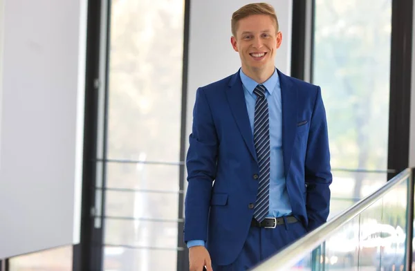 Portrait Smiling Young Businessman Standing Window Office — Stock Photo, Image