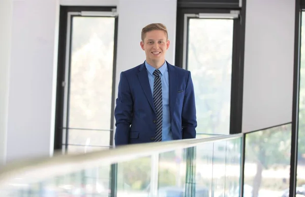 Portrait Smiling Young Businessman Standing Window Office — Stock Photo, Image