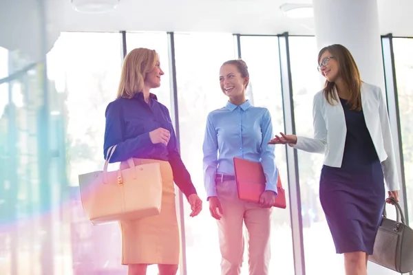 Smiling Businesswomen Talking While Walking Window Office — Stock Photo, Image