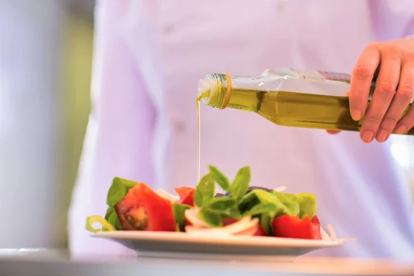 Ořezaný Obraz Kuchaře Nalévání Oleje Salát Talíři Restauraci — Stock fotografie