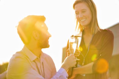 Gülümseyen çift çatıda birbirine bakıyor.