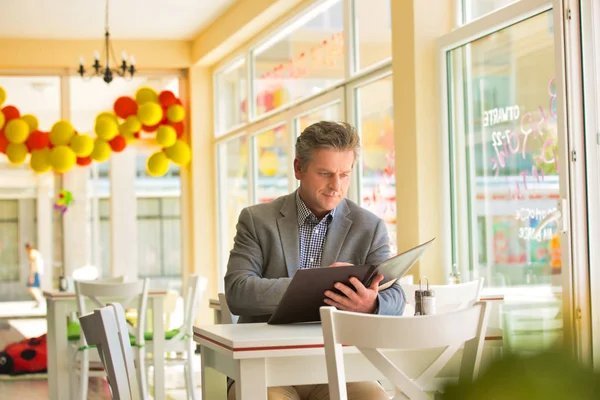 Mature Customer Reading Menu While Sitting Table Window Restaurant — Stock Photo, Image