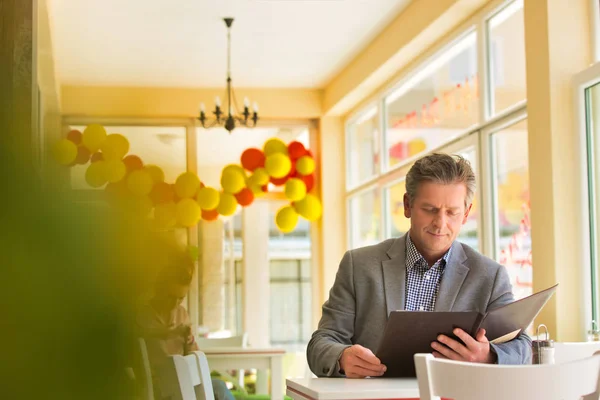 Mature Customer Reading Menu While Sitting Table Window Restaurant — Stock Photo, Image