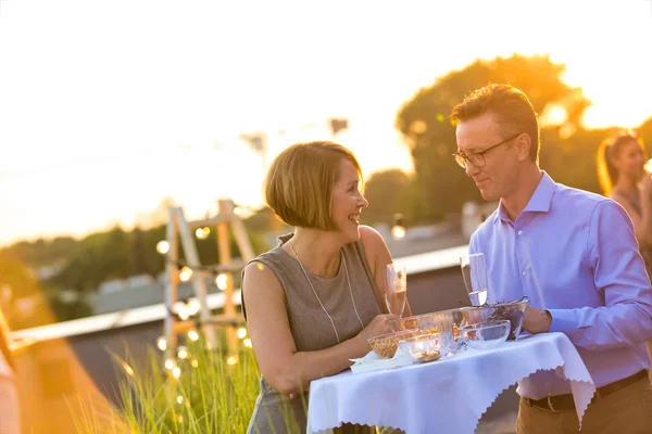 Mature business colleagues talking while standing at table durin — Stock Photo, Image