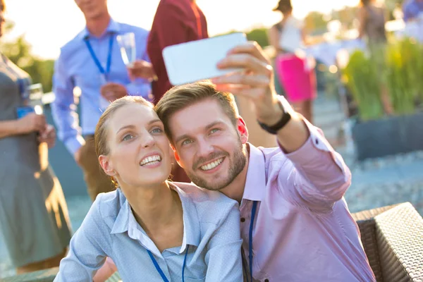 Biznesmen robi selfie z kolegą podczas imprezy na dachu — Zdjęcie stockowe