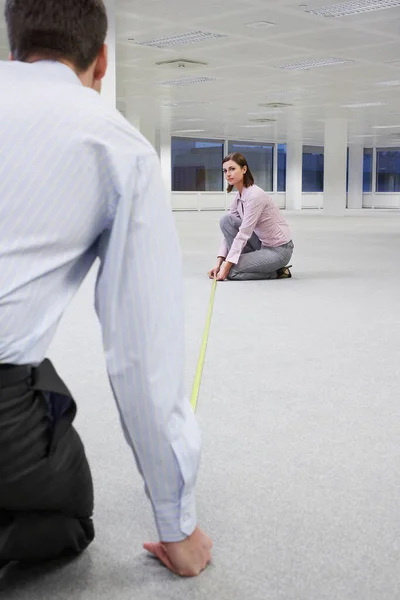 Dos Trabajadores Oficina Midiendo Piso Espacio Oficina Vacío Vista Trasera —  Fotos de Stock