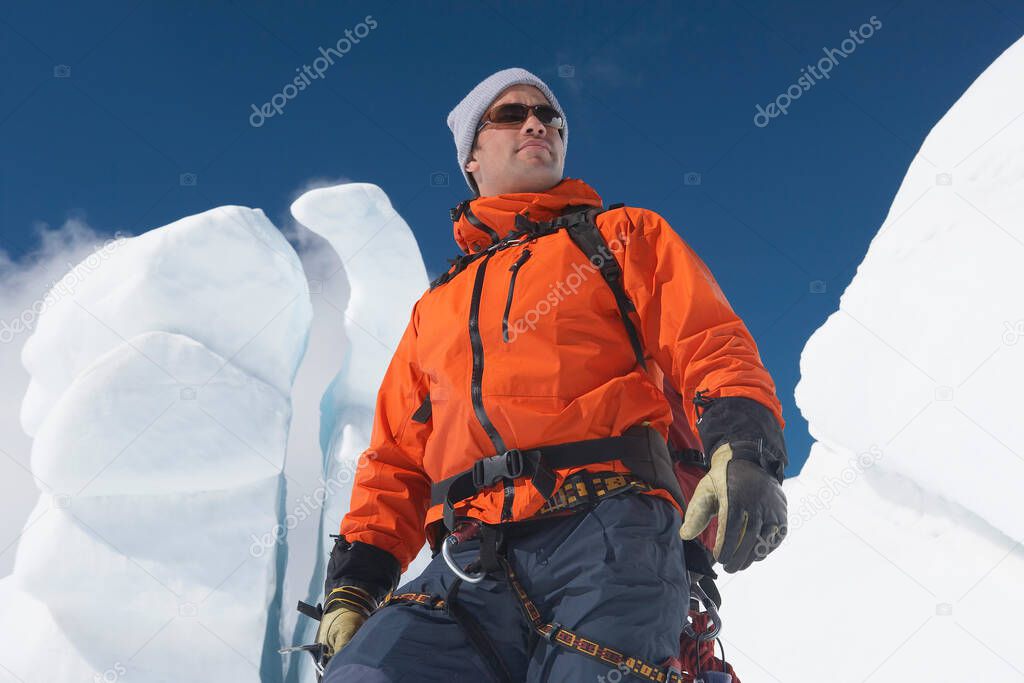 Mountain climber in front of ice formation