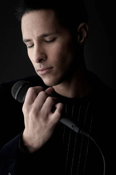 Young Man Holding Microphone Close — Stock Photo, Image