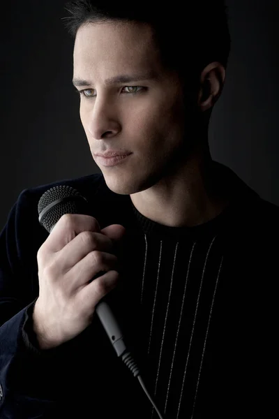 Young Man Holding Microphone Close — Stock Photo, Image