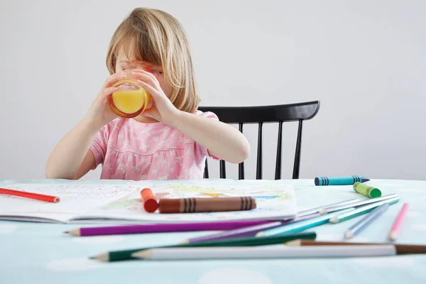 Girl Drinking Orange Juice Crayons Foreground — Stock Photo, Image