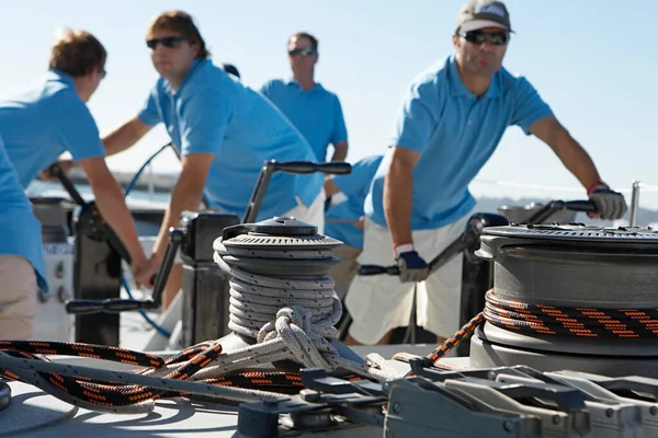 Male sailing team on yacht