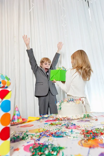 Sister Giving Gift Surprised Birthday Boy Arms Raised — Stock Photo, Image