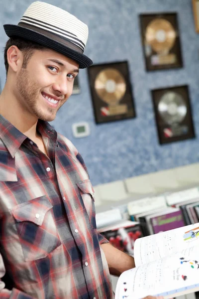 Portrait Happy Young Male Music Store Book — Stock Photo, Image