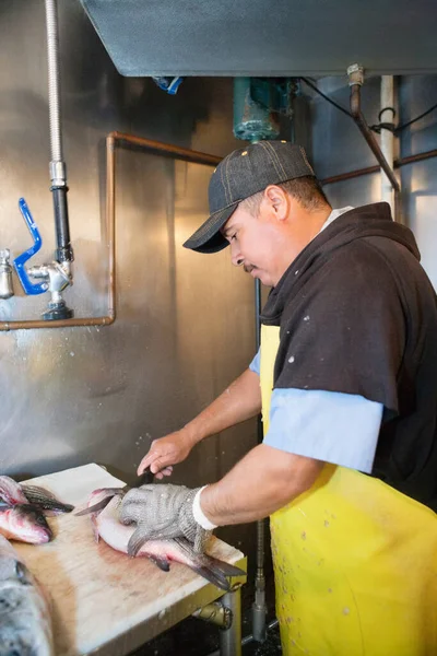 Gammal Manlig Fiskhandlare Som Skär Fisk Bordet — Stockfoto