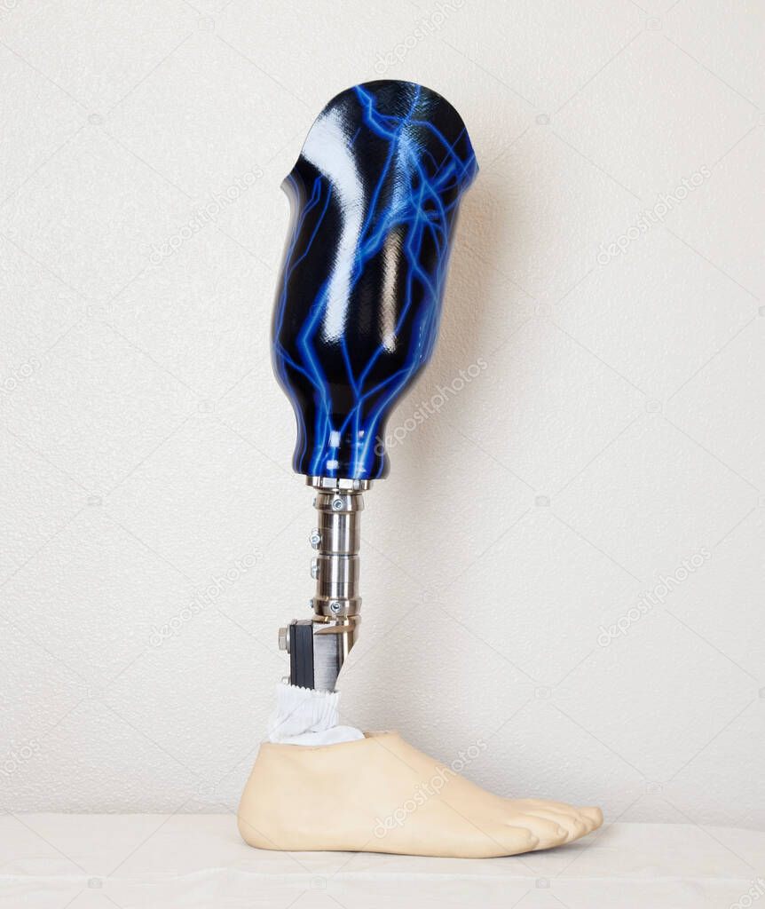 An advanced prosthetic foot over gray wall