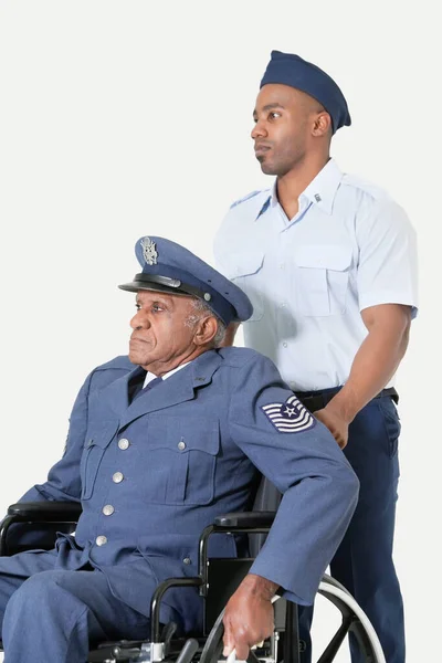 Male Cadet Assisting Senior Air Force Officer Wheelchair Light Gray — Stock Photo, Image