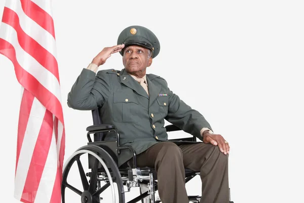 Senior Male Military Officer Wheelchair Saluting American Flag Gray Background — Stock Photo, Image