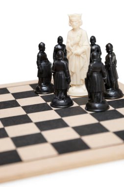 Chess game with king surrounded by black pawns clipart