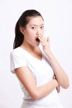 Beyaz arka planda elleri ağızlarında şok olmuş genç bir kadının portresi.