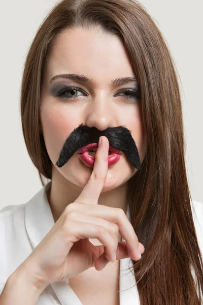 Portrait Young Woman Fake Mustache Gesturing Quiet Gray Background — Stock Photo, Image