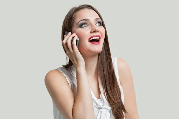 Young Woman Using Cell Phone While Looking Gray Background — Stock Photo, Image