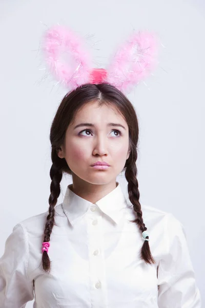 Contemplative Asian Woman Bunny Ears White Background — Stock Photo, Image
