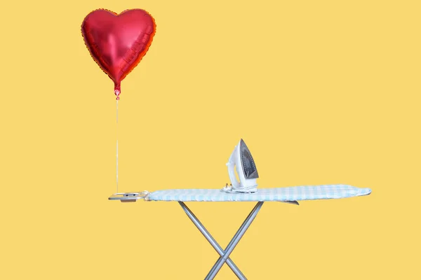 Heart Shaped Balloon Tied Ironing Board Yellow Background — Stock Photo, Image