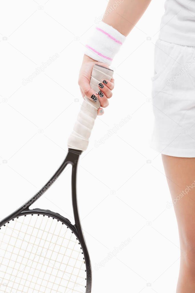 Midsection of a young Asian woman holding tennis racket over white background
