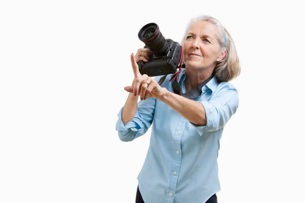 Senior Female Photographer Camera Gesturing White Background — Stock Photo, Image