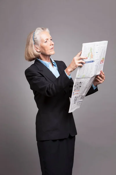 Portrait Senior Businesswoman Reading Newspaper Studio — Stock Photo, Image