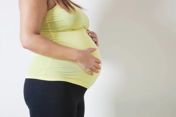 Mittelteil Einer Jungen Schwangeren Steht Vor Weißem Hintergrund — Stockfoto