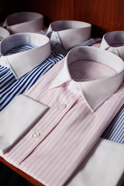 Folded shirts on shelf in a clothing store