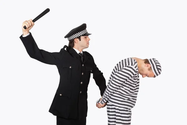 Side View Police Officer Nightstick Arresting Male Prisoner Gray Background — Stock Photo, Image